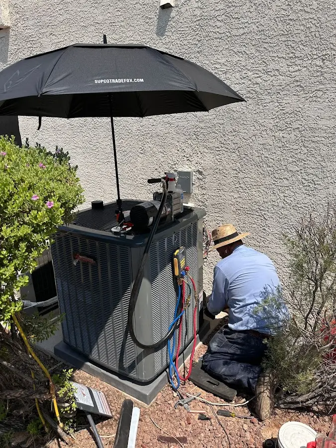HVAC technician performing outdoor AC maintenance in Mission